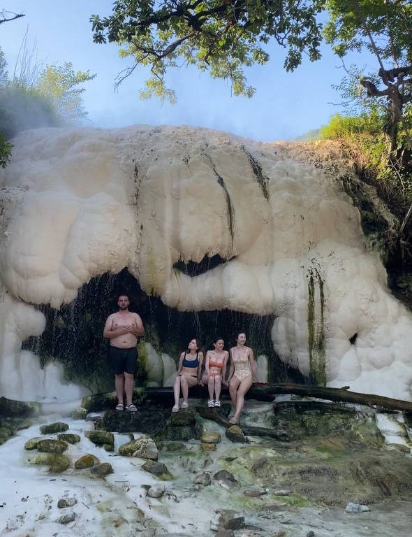 Люди греются у водопада источника Нокалакеви. Природная баня.